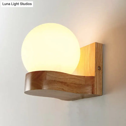 Opal Glass Wood Sconce by Decorbites with a warm round globe on a curved wood mount on Tampa Home & Garden Store