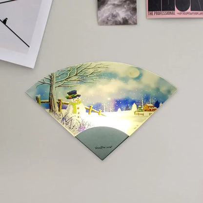White acrylic wall light with curved fan-shaped panel showing snowy scene with snowman and fence on Tampa Home & Garden Store