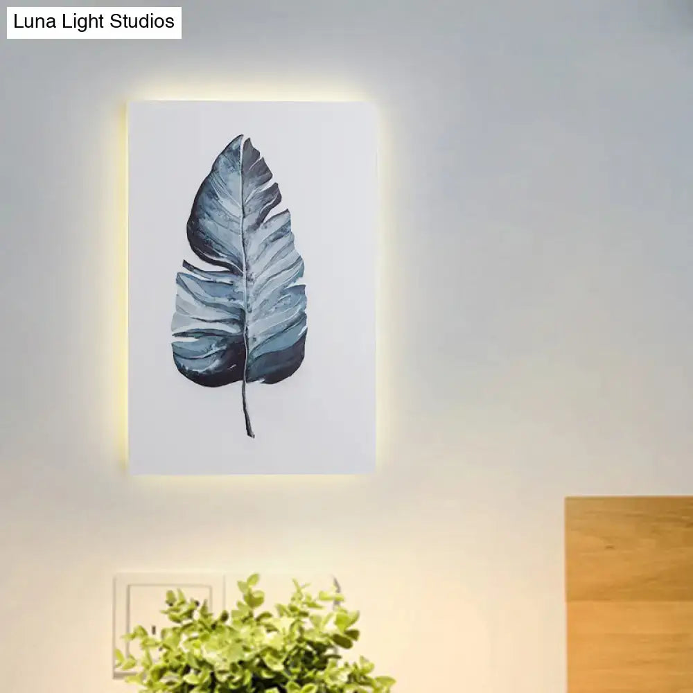 White Nordic Wall Sconce backlit framed blue leaf artwork on wall on Tampa Home & Garden Store