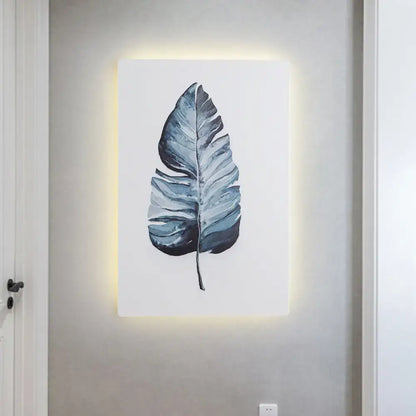 White Nordic wall sconce by Decorbites with blue leaf artwork and backlit panel on Tampa Home & Garden Store