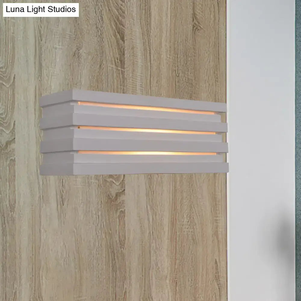 White louvered wall sconce with stacked horizontal slats and warm glow on Tampa Home & Garden Store