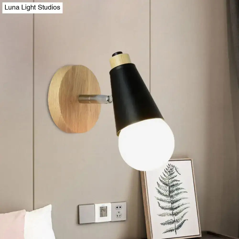 Decorbites Bamboo Cone Wall Light with black tapered shade on round wooden mount, bulb lit on Tampa Home & Garden Store