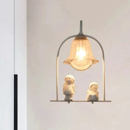 Decorbites Nordic white arched frame flower glass pendant light with warm glow over two figurines on Tampa Home & Garden Store