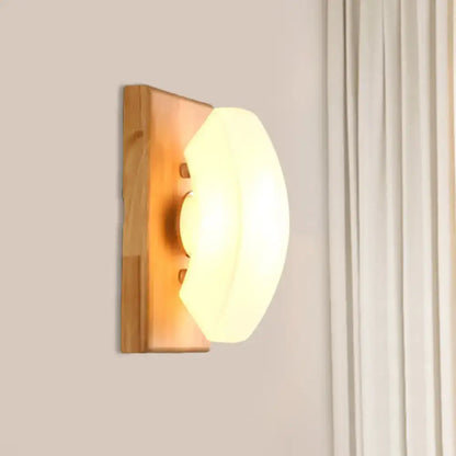 White frosted glass wood-back wall sconce by Decorbites with warm glow on Tampa Home & Garden Store