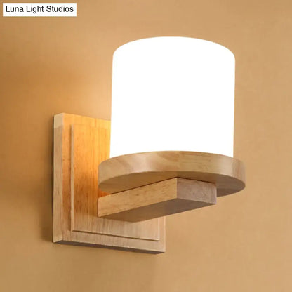 Wood Opal Wall Sconce by Decorbites with backplate and curved arm supporting an opal shade on Tampa Home & Garden Store