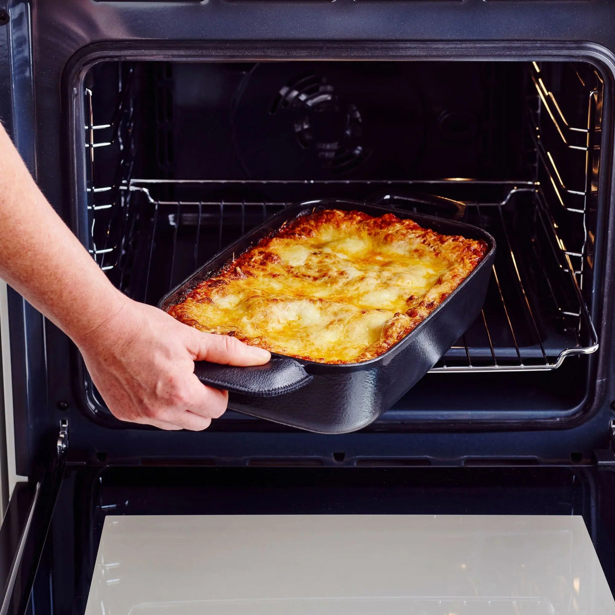 Enameled cast iron roasting pans, 12x8 in, Alva Cookware, 2 pans being removed from oven on Tampa Home & Garden Store