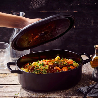 Enameled Cast Iron Oval Dutch Oven, 6-Qt by Alva Cookware; black enamel exterior, vegetable stew on Tampa Home & Garden Store