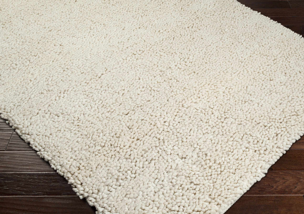 Oakridge Area Rug cream shaggy pile on dark wood floor Boutique Rugs on Tampa Home & Garden Store
