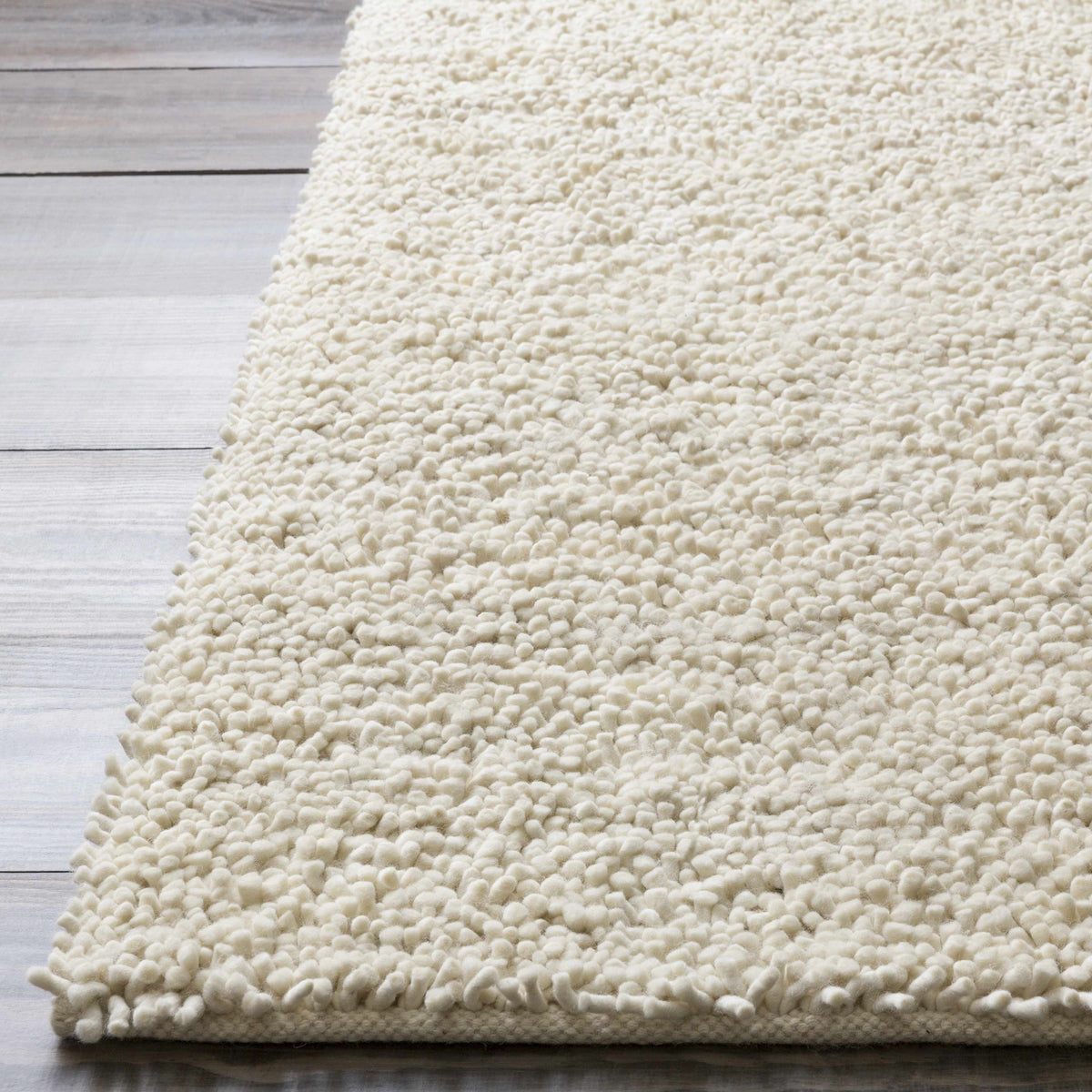 Oakridge Area Rug ivory shag pile by Boutique Rugs, plush tufted texture on light wood floor on Tampa Home & Garden Store
