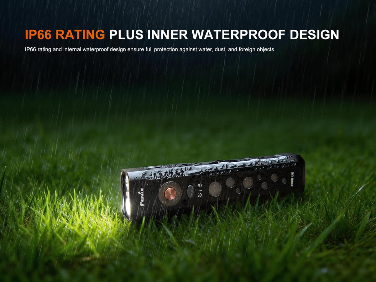 Fenix E08R UE EDC flashlight on rain-soaked grass, black handheld torch with copper button on Tampa Home & Garden Store