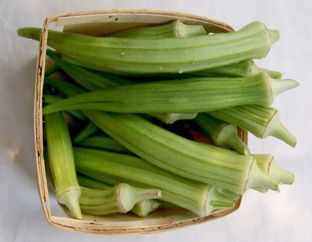 Burmese Okra seeds in a wicker basket with fresh green okra pods on Tampa Home & Garden Store