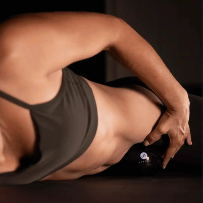 Orbit muscle release tool by Aletha Health; black device near forearm with dark tank top on Tampa Home & Garden Store