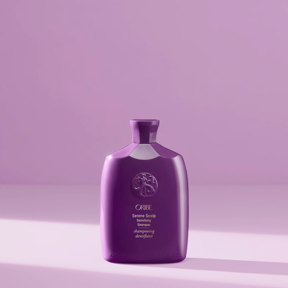 Oribe Serene Scalp Densifying Shampoo bottle in glossy purple with crest emblem on Tampa Home & Garden Store