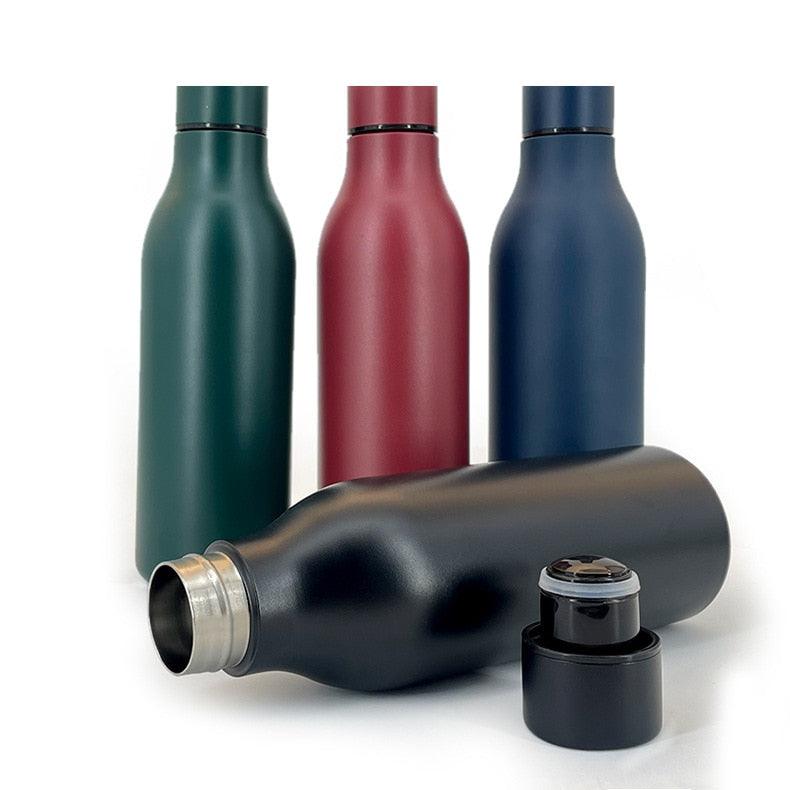 Set of four stainless steel water bottles in green red blue and black with cap removed on Tampa Home & Garden Store