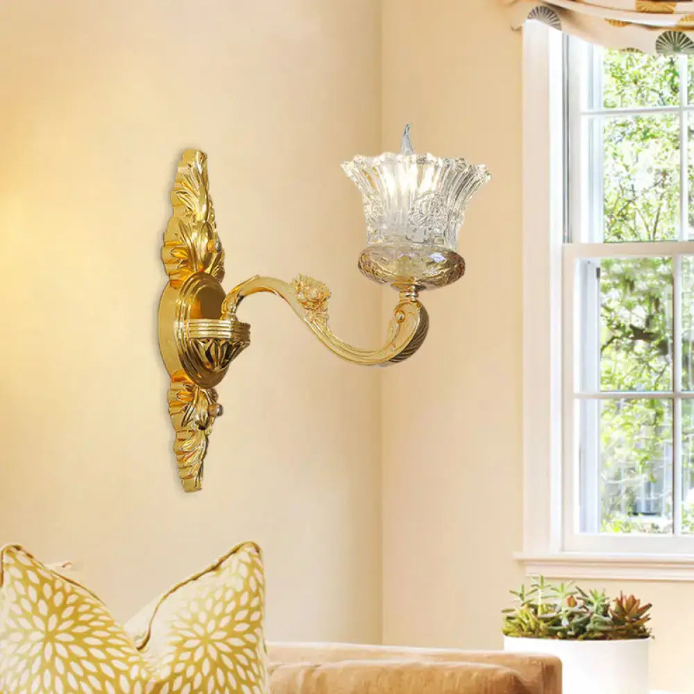 Gold flower crystal sconce by Decorbites with ornate brass arm and glass shade on wall on Tampa Home & Garden Store