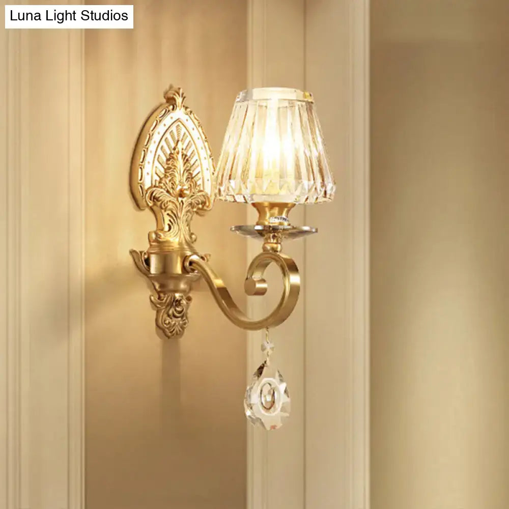 Gold crystal prismatic wall sconce by Decorbites with brass backplate and curved arm on Tampa Home & Garden Store