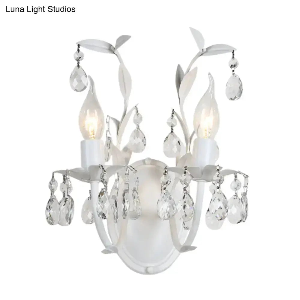 Ornate silver crystal leaf wall sconce with hanging teardrop prisms and candle bulbs on Tampa Home & Garden Store