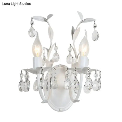 Ornate silver crystal leaf wall sconce with hanging teardrop prisms and candle bulbs on Tampa Home & Garden Store