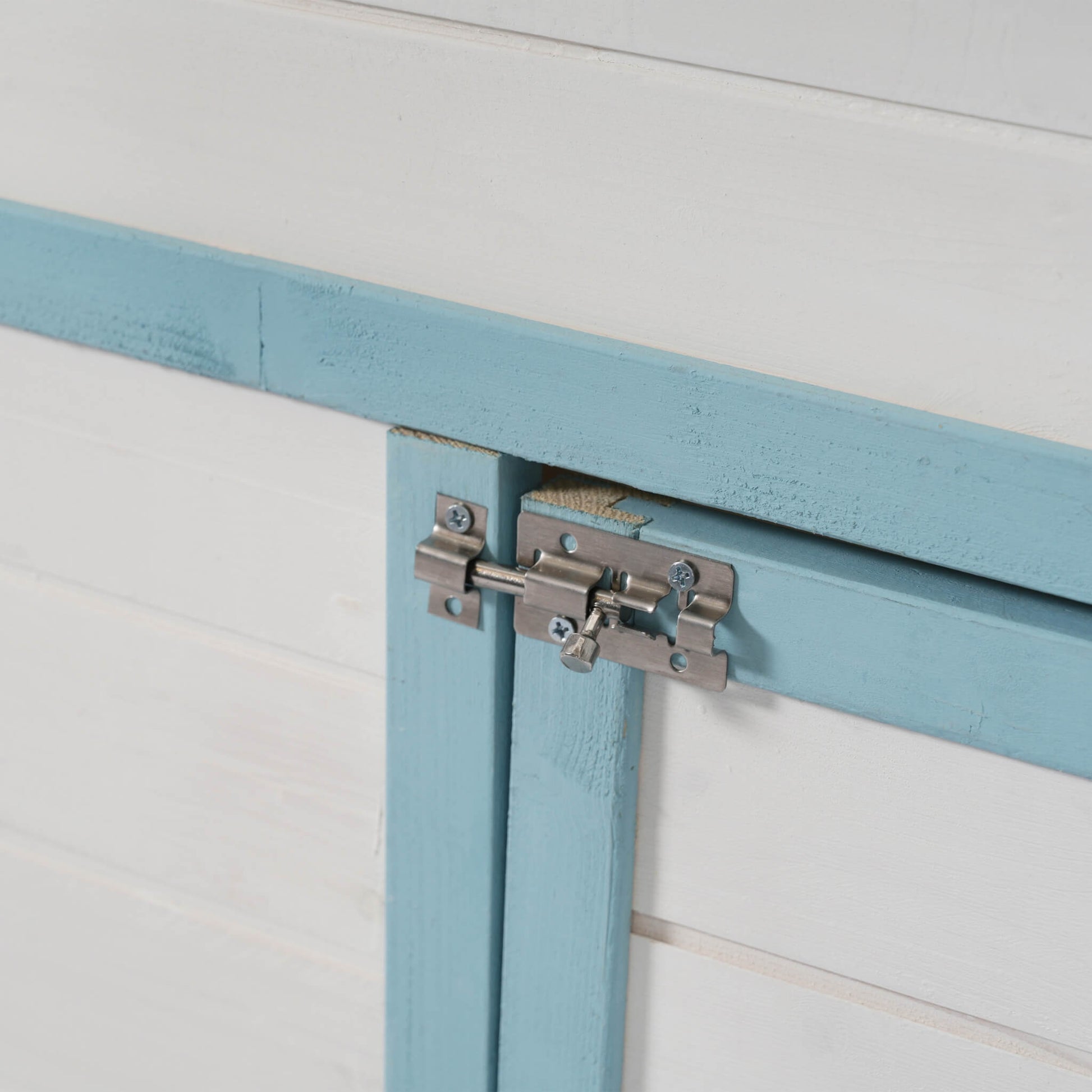 Chicken coop latch close-up on blue painted fir wood exterior for 96-inch outdoor coop on Tampa Home & Garden Store