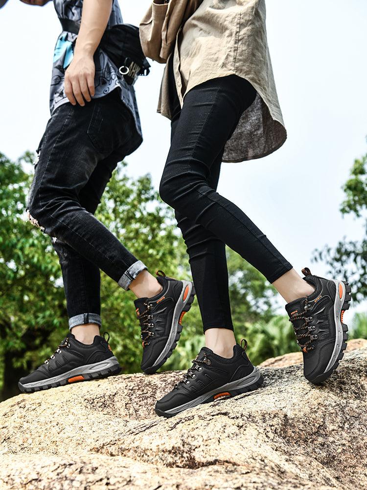 Stevvex hiking boots, waterproof, orange accents, non-slip outsole, three wearers on rock on Tampa Home & Garden Store
