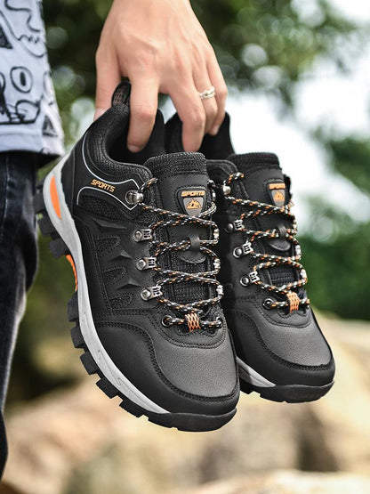 Stevvex hiking boots pair, black waterproof with orange laces and rugged outsole on Tampa Home & Garden Store