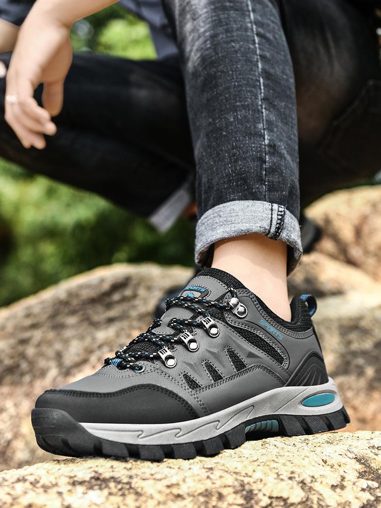Stevvex men's waterproof hiking boots gray black with rugged outsole on rocky terrain on Tampa Home & Garden Store