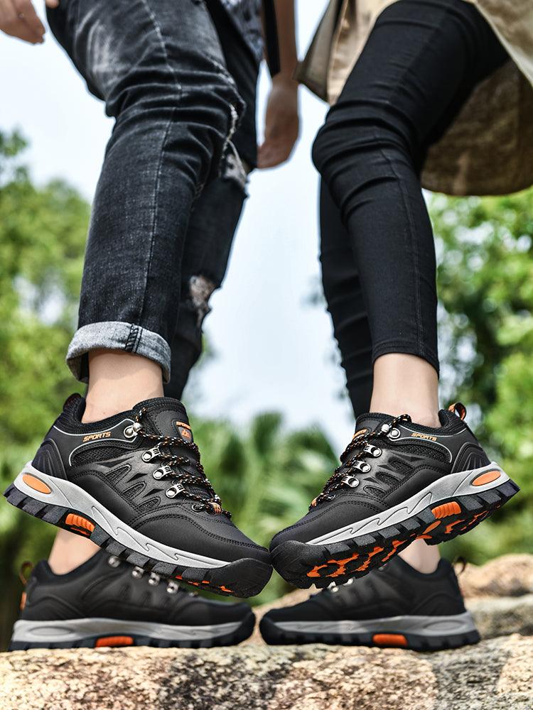 Stevvex pair of outdoor waterproof hiking boots, black with orange accents, rugged outsole on Tampa Home & Garden Store