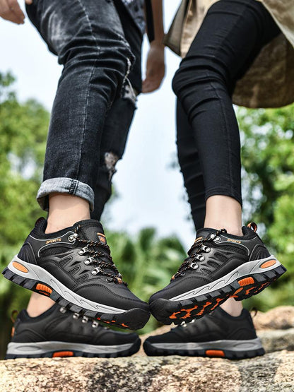 Stevvex pair of outdoor waterproof hiking boots, black with orange accents, rugged outsole on Tampa Home & Garden Store