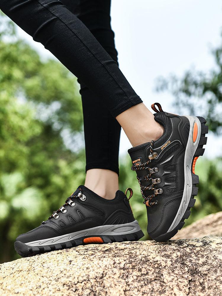 Pair of Stevvex men's waterproof hiking boots, black with grey non-slip sole, orange accents on Tampa Home & Garden Store