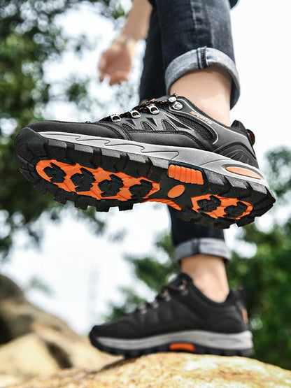 Stevvex men's hiking boots pair, black waterproof non-slip footwear with orange rugged outsole on Tampa Home & Garden Store