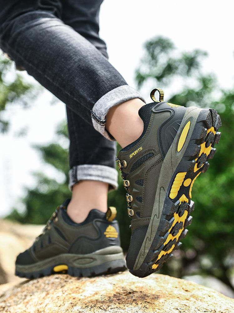 Stevvex men's hiking boots olive waterproof non-slip with rugged yellow outsole shown on rock on Tampa Home & Garden Store