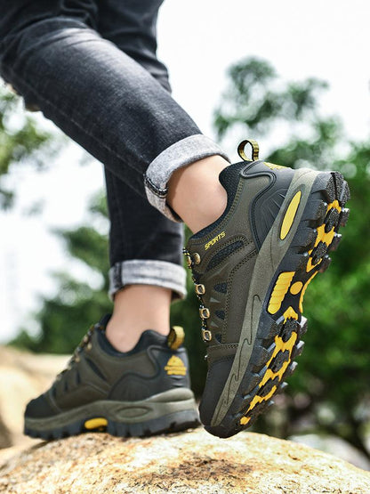 Stevvex men's hiking boots olive waterproof non-slip with rugged yellow outsole shown on rock on Tampa Home & Garden Store