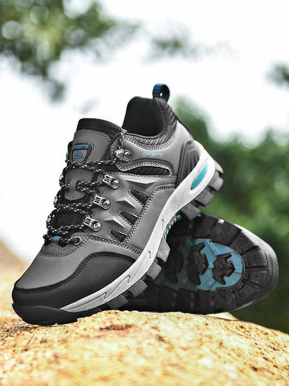 Stevvex men's outdoor waterproof hiking boots with gray/black upper and lug outsole on rock on Tampa Home & Garden Store