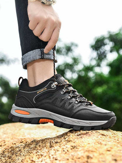 Stevvex men's waterproof hiking boots with black upper and orange accents, non-slip tread on Tampa Home & Garden Store