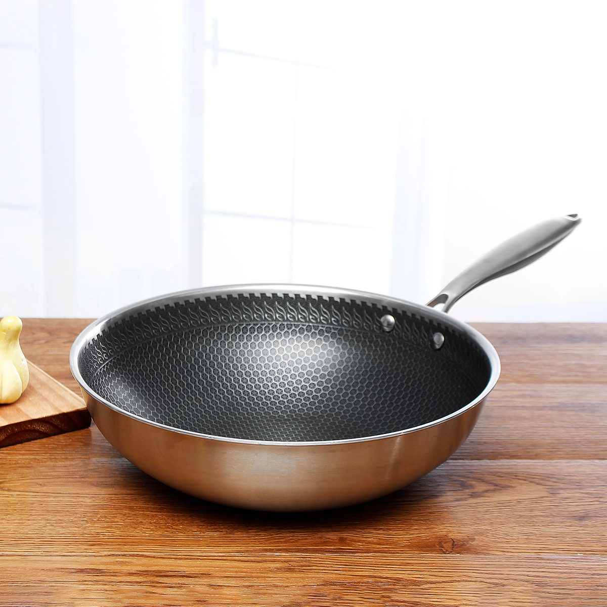 Frying pan with honeycomb textured interior, stainless steel body, riveted handle on surface on Tampa Home & Garden Store