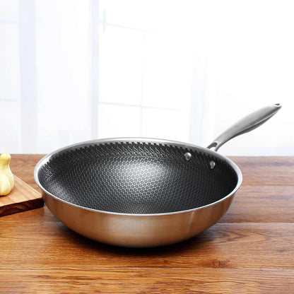 Frying pan with honeycomb textured interior, stainless steel body, riveted handle on surface on Tampa Home & Garden Store