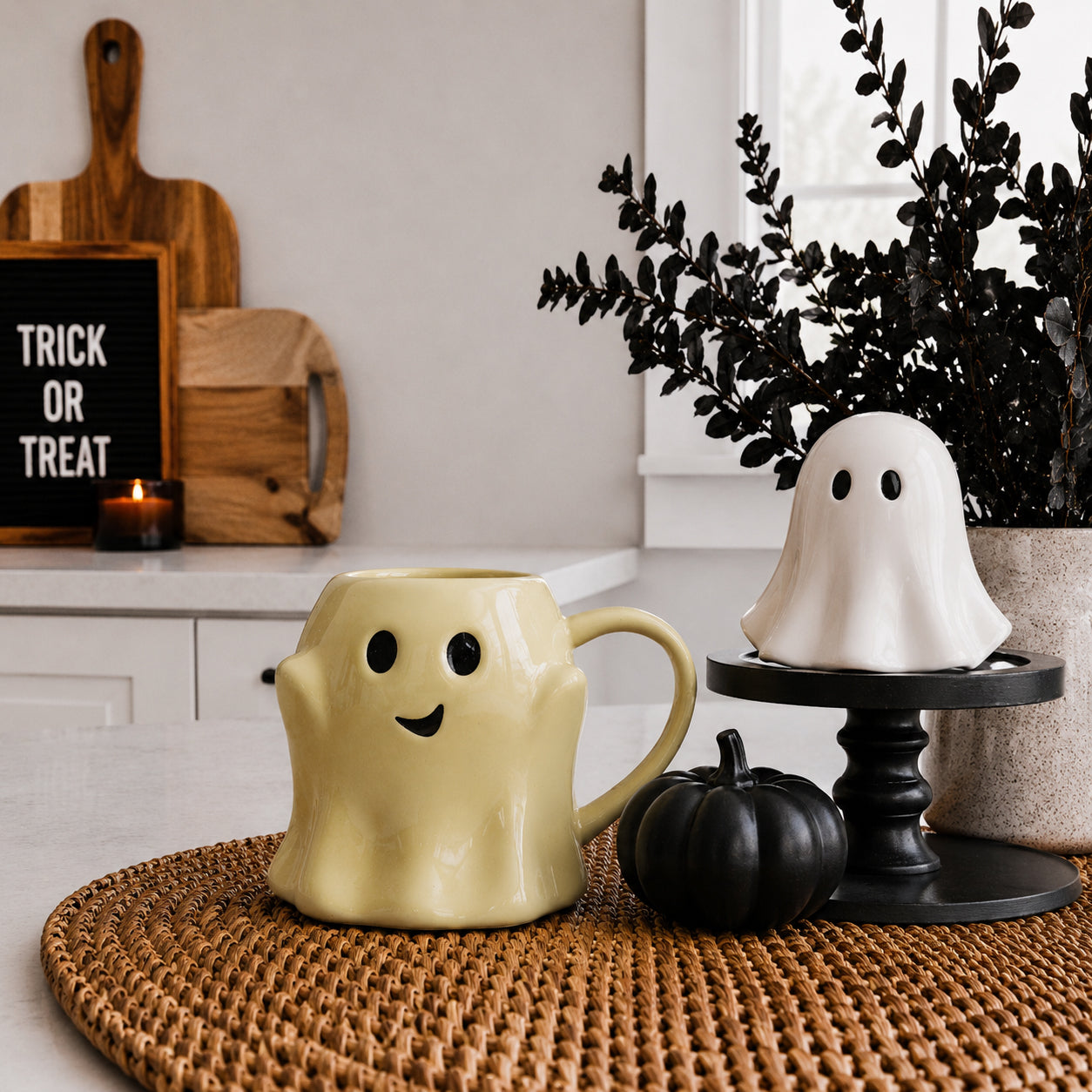 Gia Roma Ghost Mug yellow ceramic coffee mug with black eyes and smile; white ghost decor on stand on Tampa Home & Garden Store