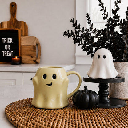 Gia Roma Ghost Mug yellow ceramic coffee mug with black eyes and smile; white ghost decor on stand on Tampa Home & Garden Store