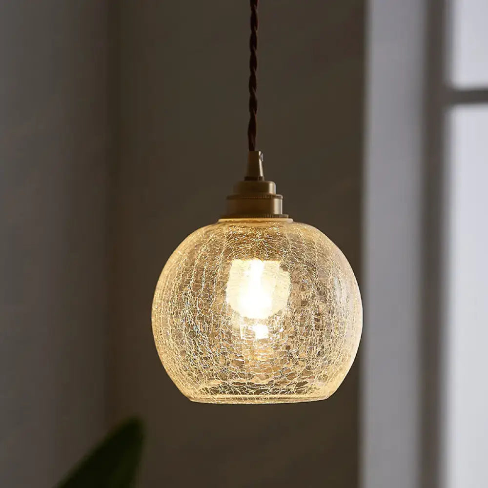 Glass sphere ceiling light pendant, crackled glass globe with brass hardware, warm glow on Tampa Home & Garden Store