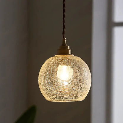 Glass sphere ceiling light pendant, crackled glass globe with brass hardware, warm glow on Tampa Home & Garden Store