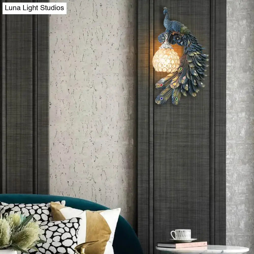Blue crystal dome wall sconce by Decorbites with peacock resin design on dark panels on Tampa Home & Garden Store