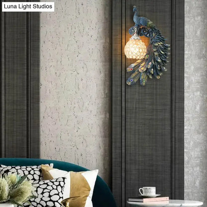 Blue crystal dome wall sconce by Decorbites with peacock resin design on dark panels on Tampa Home & Garden Store