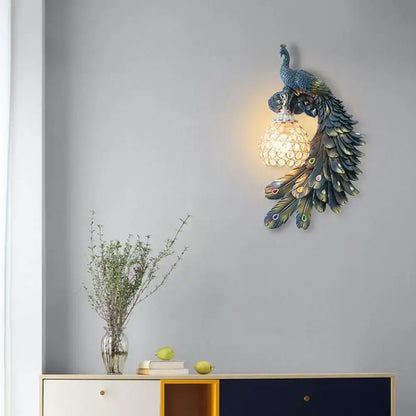 Blue crystal dome wall sconce with resin peacock design and warm glow on Tampa Home & Garden Store