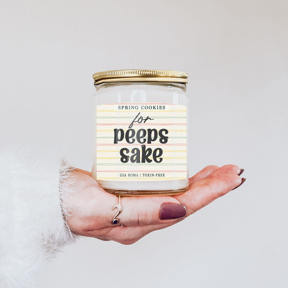 Easter Cookie Candle Gia Roma in a clear glass jar with pastel striped label and gold lid on Tampa Home & Garden Store