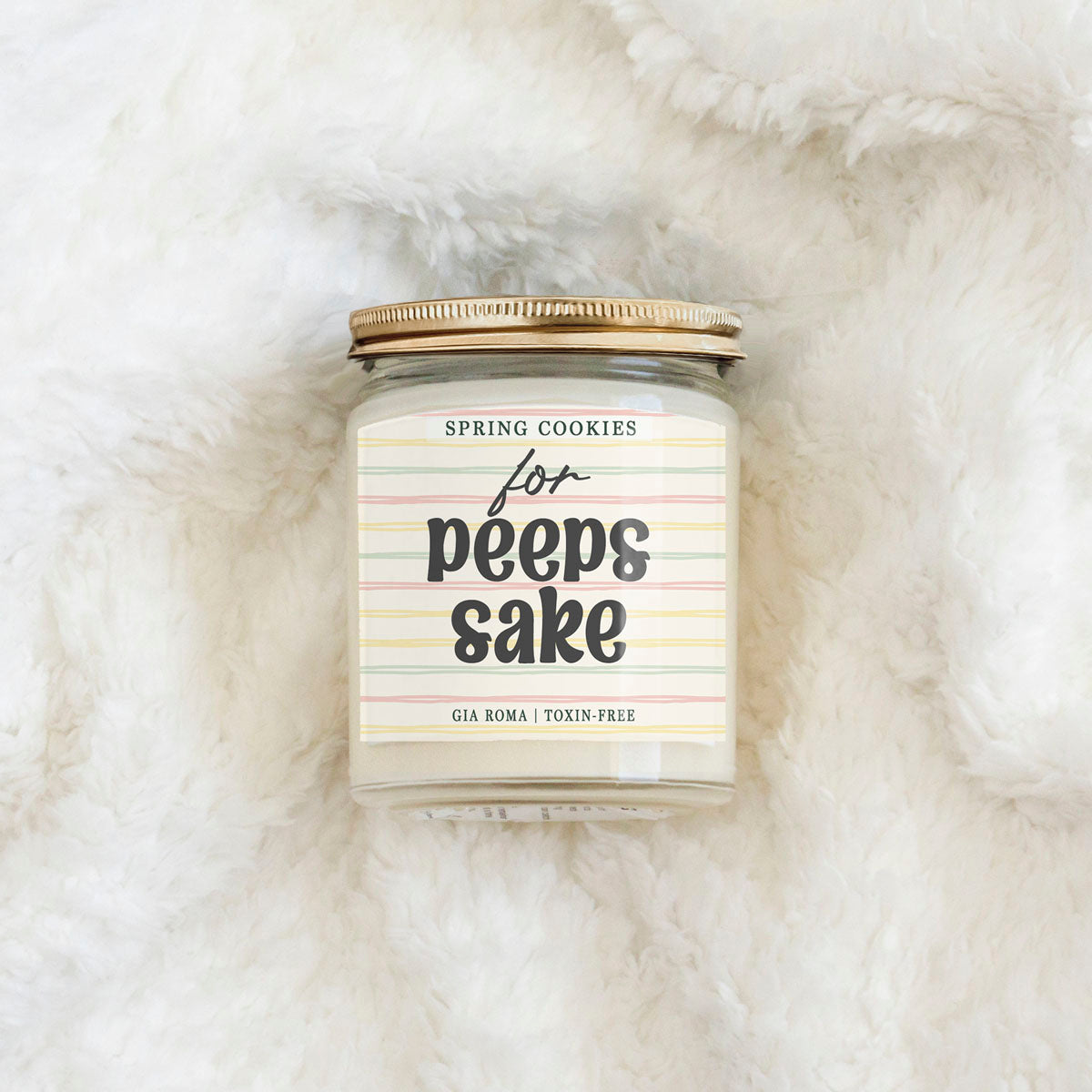 Easter Cookie Candle Gia Roma with pastel striped label on a clear glass jar and copper lid on Tampa Home & Garden Store