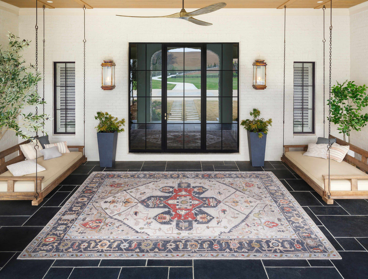 Halayhayin Premium Rug by Boutique Rugs beige area rug with red and blue motifs on a porch on Tampa Home & Garden Store