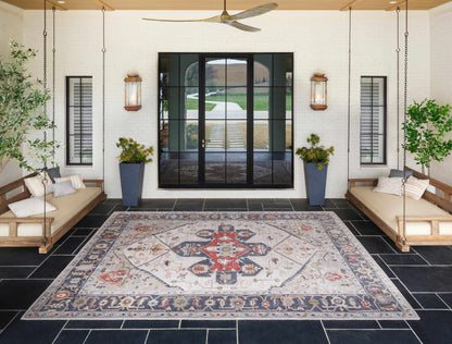 Halayhayin Premium Rug by Boutique Rugs beige area rug with red and blue motifs on a porch on Tampa Home & Garden Store