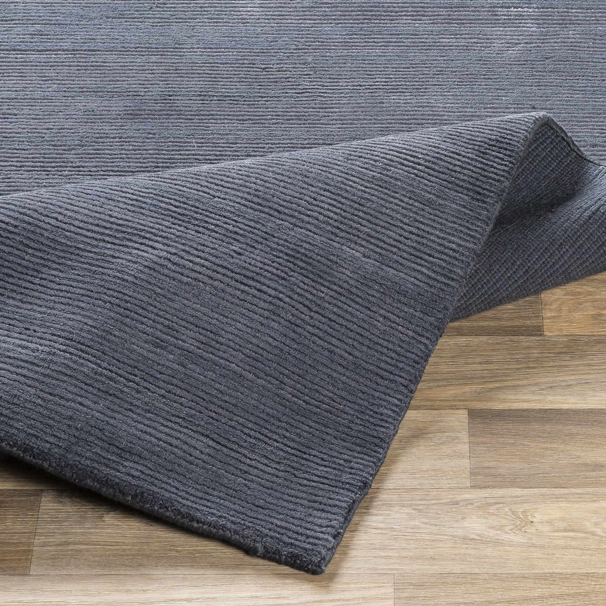Philipsburg Carpet in charcoal gray with ribbed texture by Boutique Rugs on wooden floor on Tampa Home & Garden Store