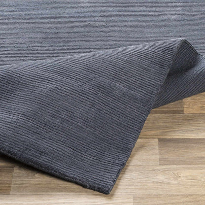 Philipsburg Carpet in charcoal gray with ribbed texture by Boutique Rugs on wooden floor on Tampa Home & Garden Store
