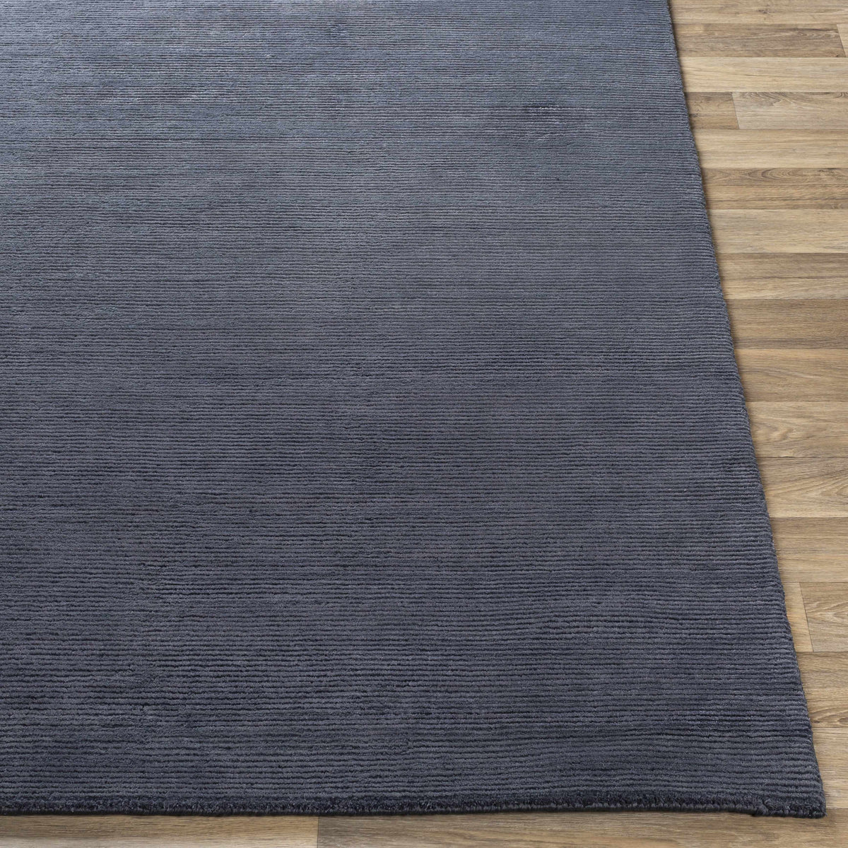 Philipsburg Carpet rug in blue-gray with ribbed texture by Boutique Rugs on hardwood floor on Tampa Home & Garden Store